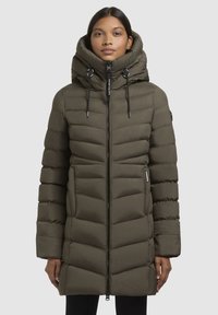 Olive green puffer coat with a high collar, zip closure, and horizontal quilted pattern. Features drawstring accents and side pockets.