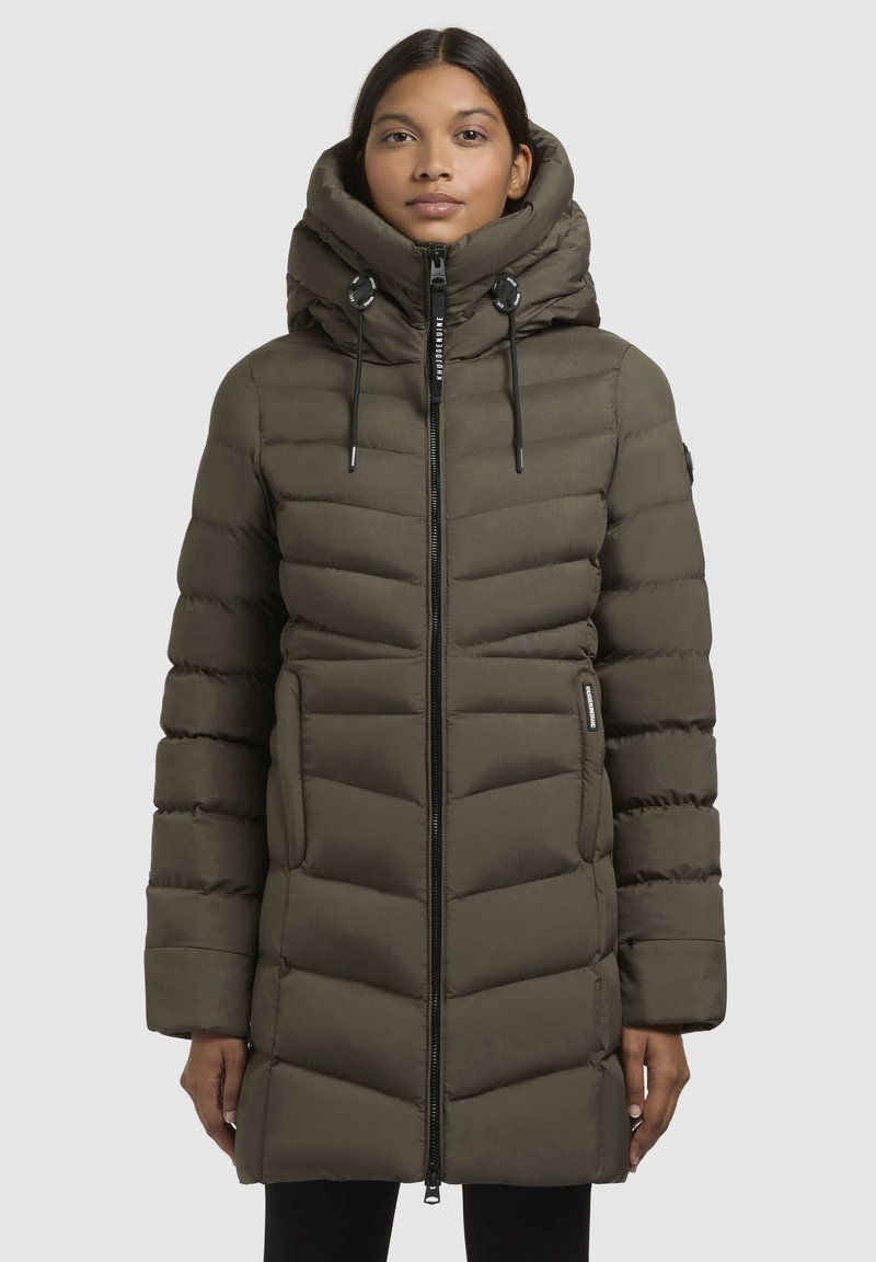 Olive green puffer coat with a high collar, zip closure, and horizontal quilted pattern. Features drawstring accents and side pockets.