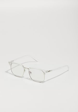 Lunettes optiques transparentes avec des verres carrés, monture légère et transparente, accents en métal, et branches longues et fines.