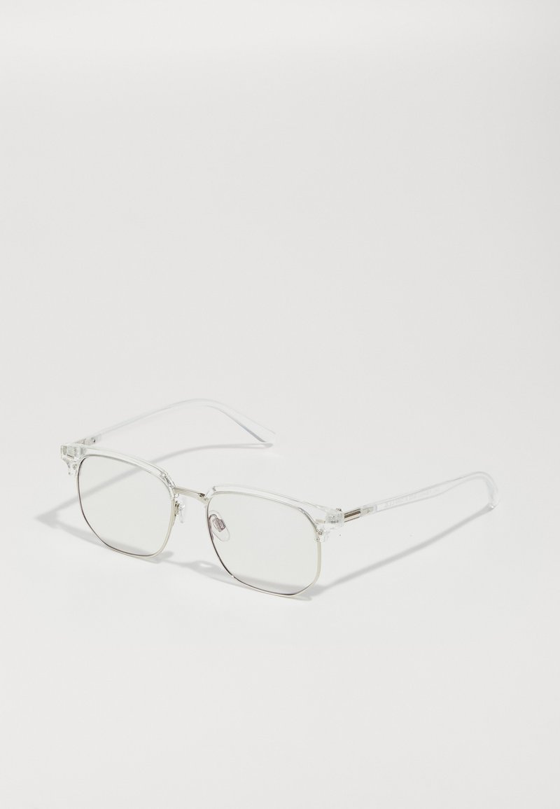 Clear optical glasses with a square lens shape, lightweight transparent frame, metal accents, and long, slender temple arms.