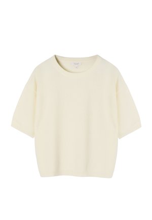 Trumpomis rankovėmis, kremine megzta palaidinė su apvalia kaklo iškirpte, ribotais rankogaliais ir apačia, rodoma ant balto pagrindo.