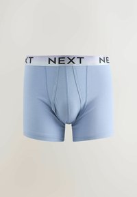 Boxers homme bleu clair avec ceinture élastique blanche portant un texte noir « NEXT », affichés sur un fond clair uni.