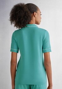 Intimissimi KURZÄRMELIGES, VORNE OFFENES - Pyžamový top - blau lagoon blue