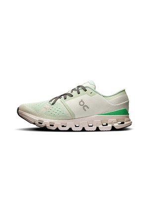 Light green running shoe with textured mesh upper, gray laces, and white outsole featuring large circular cutouts. Subtle branding accent.