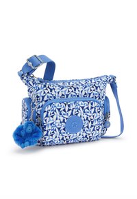Piccola borsa a spalla blu e bianca con motivo, tasca con zip frontale, tracolla regolabile e portachiavi con scimmietta pelosa blu attaccata.