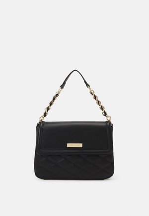 Black quilted handbag with a smooth leather flap, gold chain strap, and a rectangular shape. Features a metallic brand plaque on the front.