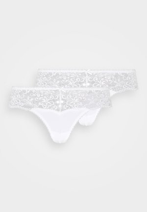 White lace thongs featuring a floral pattern, a soft waistband, decorative bows, and smooth white fabric at the back. Pack of two.