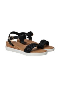 Sandales à brides noires tressées avec semelle en liège, semelle extérieure en caoutchouc blanc, brides noires ajustables et semelle intérieure rembourrée couleur tan.