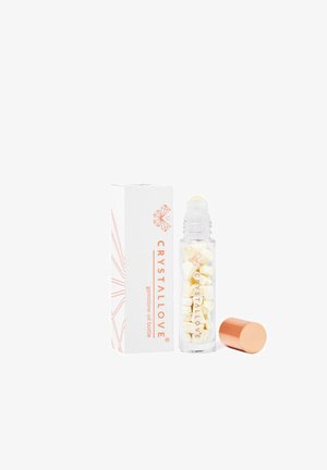 Bottiglia in vetro con roll-on e tappo dorato, riempita con piccoli pezzi di cristallo. La scatola bianca presenta un logo arancione e un design geometrico.