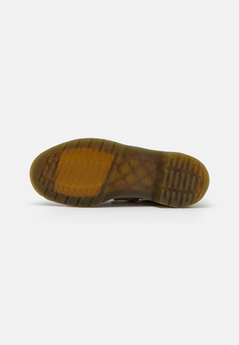Semelle en caoutchouc avec un motif de relief texturé ; base de chaussure brun-gris avec un léger éclat ; design adaptable pour une utilisation en extérieur.