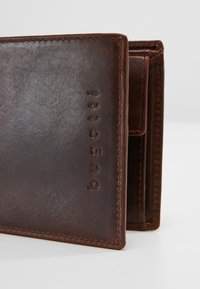 Brown leather wallet with embossed logo, stitched edges, a compact design, and multiple card slots visible with a textured finish.