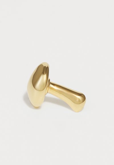 Gold-toned mushroom-shaped object with a smooth, reflective surface; features a tapered handle for easy grip.