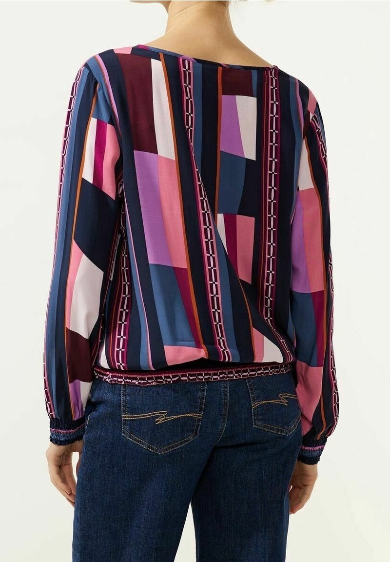 Long-sleeve top in multicolored geometric patterns with shades of pink, purple, and navy. Features elasticated waistband and cuffs.