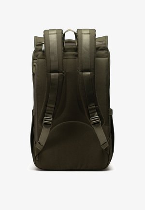 Dark olive green backpack with padded back, adjustable straps, and a top handle. Features smooth fabric and a zippered compartment on the side.