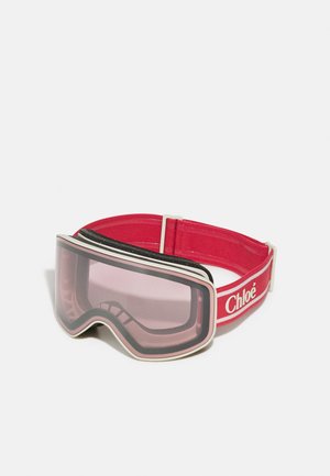 Skibril met een rode band, wit logo en zachte padding. De lens is getint in het roze, heeft een gebogen vorm en een gladde afwerking.