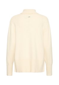 Pull à manches longues couleur crème avec un col montant et des poignets côtelés, vu de dos sur fond blanc.