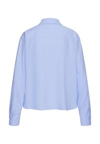 Light blue long-sleeve shirt made of soft fabric. Features a classic collar, buttoned cuffs, and a relaxed, boxy cut.
