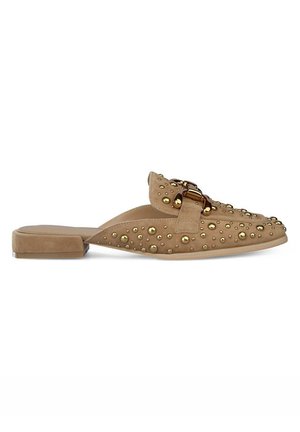 Tan suede slide shoe with rounded toe, flat heel, adorned with gold studs and a bold decorative buckle on the upper.