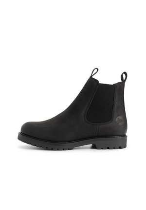 Black leather Chelsea boot with elastic side panels, pull tabs on front and back, and a textured lug sole.