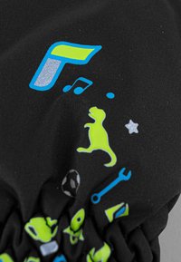 Tessuto nero con grafiche colorate, inclusi un dinosauro verde, note musicali e vari icone giocosi. Texture liscia con dettagli elastici.