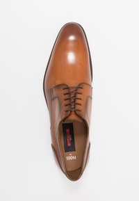 Brown leather dress shoe featuring a smooth finish, pointed toe, subtle stitching, and thin lace-up design. Interior shows branding.