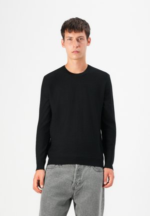 Black knitted sweater with a crew neckline, long sleeves, and a fitted silhouette. The fabric appears smooth and soft with minimal detailing.
