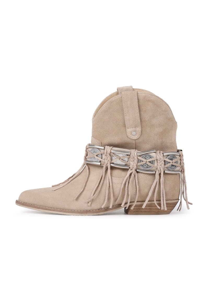 Beige suede ankle boot with a fringed design and decorative silver accents on the band. Features a low block heel and pointed toe.