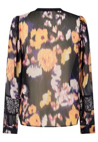 Blouse noire à manches longues avec un grand imprimé floral jaune et violet et un détail en dentelle noire sur les manches, vue de dos.