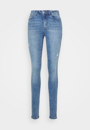 Jeans skinny feitos de denim na cor azul clara. Apresenta um ligeiro desgaste e pequenas áreas desgastadas na frente. Design clássico de cinco bolsos.
