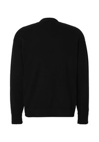 Pull noir à manches longues avec ourlet et poignets côtelés, montré de dos sur un fond blanc.