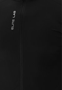 Schwarze Radjacke mit durchgehendem Reißverschluss. Hergestellt aus glattem Stoff mit einem dezenten Glanz. "ELITE LAB"-Logo in Silber auf der Vorderseite.