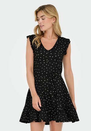Robe noire à pois, avec un décolleté en V, des manches à volants, une taille nouée et une jupe évasée avec un ourlet superposé. Matériau en coton.