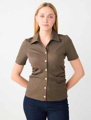 Dunkelbraunes Kurzarmhemd mit Kragen, gerüschten Seiten und goldfarbenen Knopfdetails an der Vorderseite. Glatte Textur.