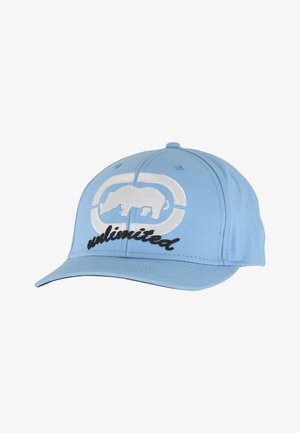 Taivaansininen baseball-lippis, jossa on valkoinen kirjailtu sarvikuonokuvio ja mustalla käsinkirjoitetulla tyylillä sana "unlimited". Lippiksessä on jämäkkä muoto ja kaartuva lippa.