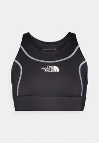 Svart sport-bh i strechtyg, med rund halsringning, kontrasterande vit sömnad och en logotyp centrerad på framsidan.