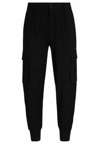 Pantalones cargo negros con dos bolsillos laterales, diseño ajustado, puños elásticos y cierre de botón. Fabricados con una tela tejida suave.