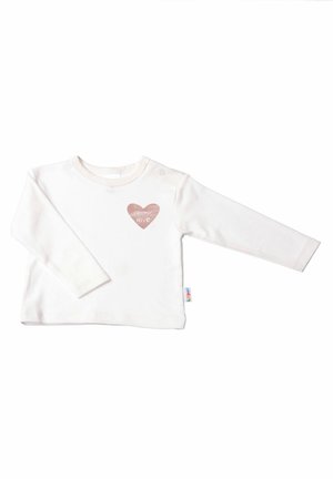 White long-sleeve top in soft fabric, featuring a heart graphic with the text "cosmic love" in pink. Includes a snap closure at the shoulder.