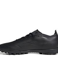 Black athletic shoes with a sleek, textured synthetic upper, featuring diagonal grooves and a rubber cleated sole for traction.