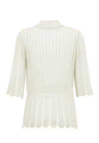 Cardigan chiaro in crema con maniche corte, design a coste, bordi ondulati e una vestibilità ampia. Materiale a maglia texturizzato.