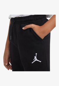 Jordan ESSENTIALS PANT UNISEX - Pantalones deportivos - black