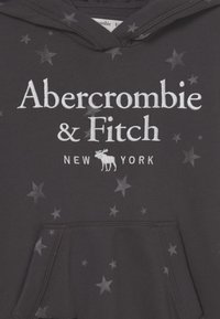Dark hoodie with Abercrombie & Fitch New York logo, moose emblem, and scattered star pattern on fabric.