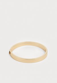 Kollane metallist bangles, millel on sirge, ristkülikukujuline kuju ja sile pind. Varustatud väikese lukuotsaga, et kinnitamine oleks kindel.