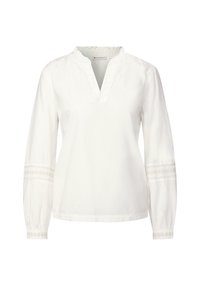 Vit långärmad blus med ruggad halsringning och en partiell knäppning. Har texturerade detaljer på ärmarna. Tillverkad av bomull.