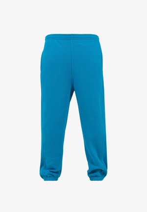 Pantaloni della tuta turchese con vita e polsini elasticizzati, realizzati in tessuto morbido, caratterizzati da una texture liscia e senza motivi visibili.