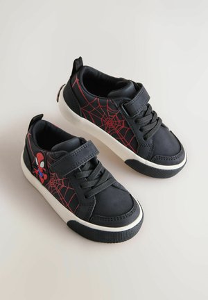 Czarne sneakersy z czerwonym wzorem pajęczyny i grafiką pająka. Zawierają regulowany pasek oraz teksturowaną gumową podeszwę. Gładki materiał górny.
