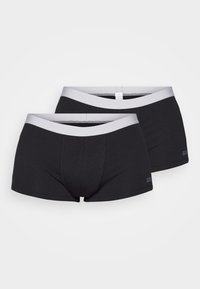 Schwarze Boxer-Brief aus weichem Stoff, mit einem kontrastierenden grauen elastischen Bund und einer engen Passform mit minimalen Nähten.
