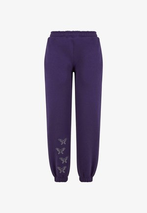 Lila Jogginghose mit elastischem Bund und Bündchen, verziert mit Strass-Schmetterlingen entlang des linken Beins. Glatte Stofftextur.