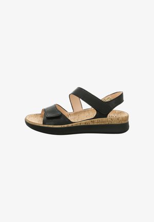 Black sandal featuring two adjustable straps, cork footbed, textured sole, and a low wedge heel for comfort and support.