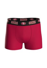 Punaiset bokserit, jotka on valmistettu joustavasta kankaasta ja joissa on musta vyötärönauha, jossa toistuu "49ERS"-logo ja tyylitelty SF-embleemi.