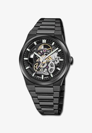 Black metal wristwatch with skeleton dial showing internal gears, white hour markers, luminescent hands, and Festina Swiss made branding.